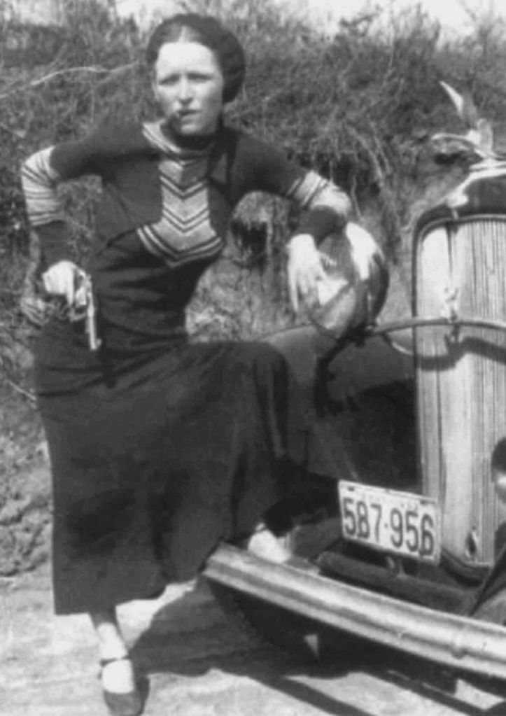 Bonnie Parker with cigar in Front of a Stolen Ford 1933