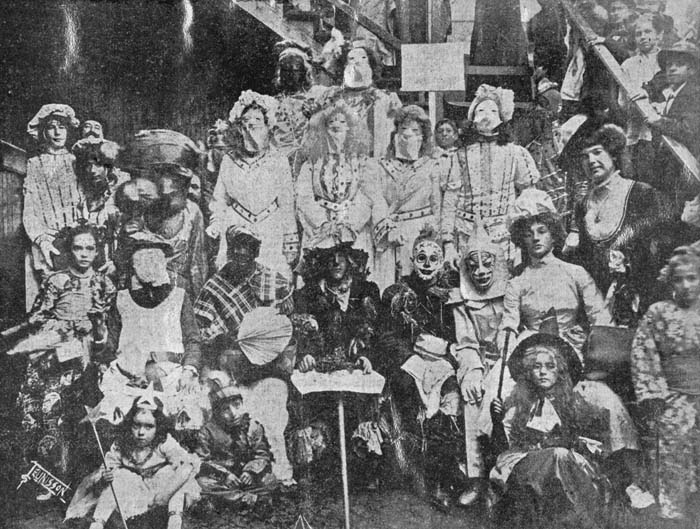 A group of masked and costumed Mardi Gras revelers on Frenchman Street, New Orleans in 1910. Photograph by John N. Teunisson.